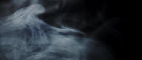  White smoke floating and drawing swirls and desappearing on dark background in 4K video