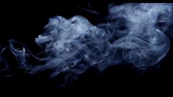 Great plasma effect created by swirls of white smoke with black background in 4K video