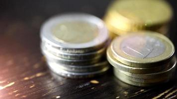 Euro coin on wooden table- financial power concept, closeup dolly shot