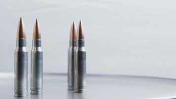 Cinematic rotating shot of bullets on a metallic surface - BULLETS 025 video