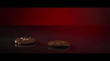 Falling cookies from above onto a reflective surface - COOKIES 200 video
