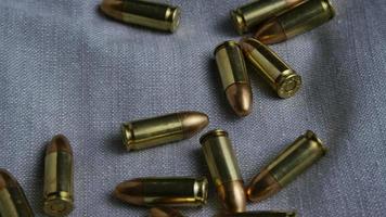 Cinematic rotating shot of bullets on a fabric surface - BULLETS 087 video