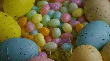 Rotating shot of Easter decorations and candy in colorful Easter grass  video
