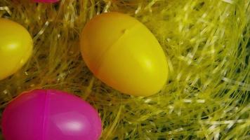 Rotating shot of Easter decorations and candy in colorful Easter grass - EASTER 002 video