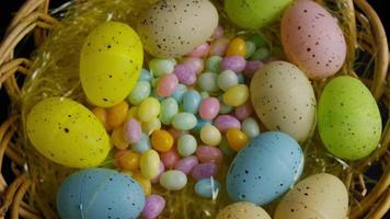 Rotating shot of Easter decorations and candy in colorful Easter grass - EASTER 056 video