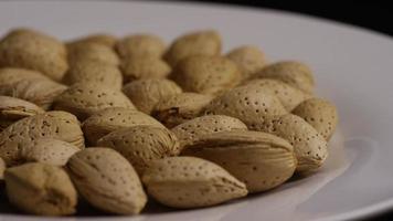 Cinematic, rotating shot of almonds on a white surface - ALMONDS 093 video