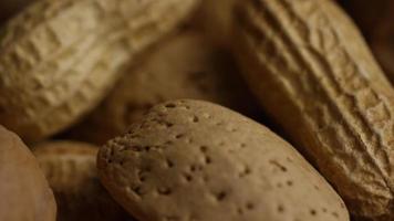 Cinematic, rotating shot of a variety of nuts on a white surface - NUTS MIXED 027 video