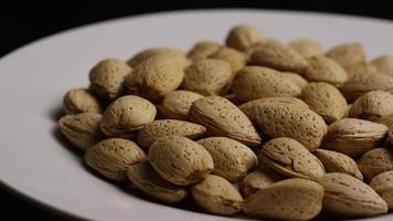 Cinematic, rotating shot of almonds on a white surface - ALMONDS 155 video