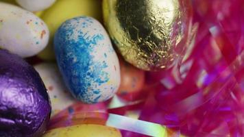 Rotating shot of colorful Easter candies on a bed of easter grass - EASTER 167 video