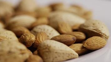 Cinematic, rotating shot of almonds on a white surface - ALMONDS 186 video