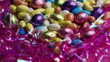 Rotating shot of colorful Easter candies on a bed of easter grass - EASTER 173 video