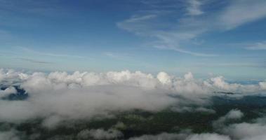 Aerial view wide shot point of view mountain with lush trees and foggy clouds video