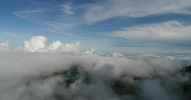 Aerial view wide shot point of view mountain with lush trees and foggy clouds video