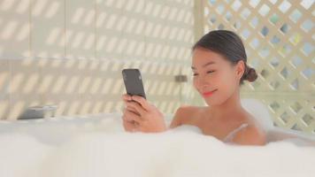 Young Asian woman relaxing in the bathtub video