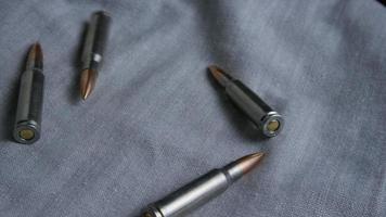 Cinematic rotating shot of bullets on a fabric surface - BULLETS 108 video