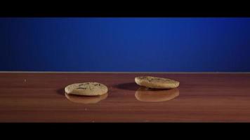Falling cookies from above onto a reflective surface - COOKIES 027 video