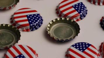 Rotating shot of bottle caps with the American flag printed on them - BOTTLE CAPS 011 video