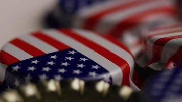 Rotating shot of bottle caps with the American flag printed on them - BOTTLE CAPS 044 video