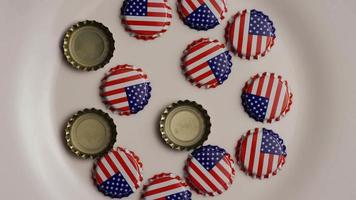 Rotating shot of bottle caps with the American flag printed on them - BOTTLE CAPS 001 video