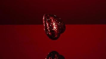 Valentine's Day decorations falling and bouncing in ultra slow motion 1,500 fps on a reflective surface - VALENTINES PHANTOM 004 video