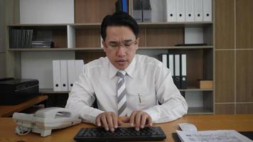 Businessman employee typing keyboard and looking at monitor computer video