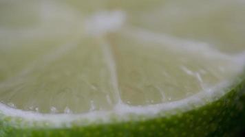 Macro of a slice of green lemon spinning video