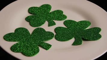 Rotating stock footage shot of St Patty's Day clovers on a white surface - ST PATTYS 007