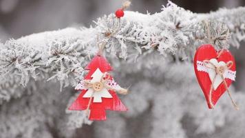 Wooden Christmas toys hanging on the branches of a Christmas tree video