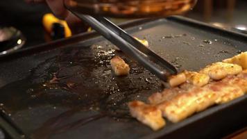 Grilling pork on the griddle video