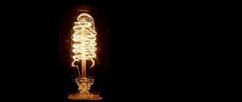 Large light bulb turning on and off with warm spring filament in 4K video
