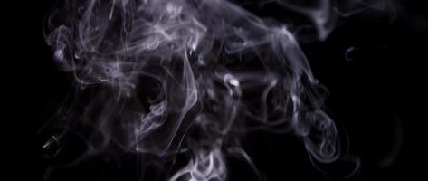 Ethereal texture of white smoke floating and creating beautiful shapes in darkness in 4K video