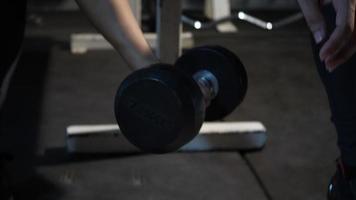Young man hand holding dumbbell up exercises at gym fitness video