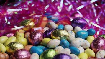 Rotating shot of colorful Easter candies on a bed of easter grass - EASTER 175 video