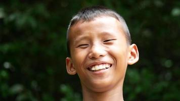 Close up of a boys face who is laughing at a funny joke video