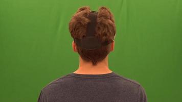 person med virtual reality-headset och grön skärm 4k video