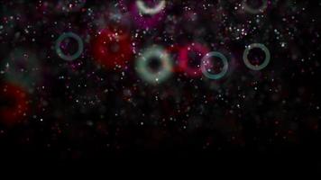 Multi colored rings and particles floating slowly on 4K dark background