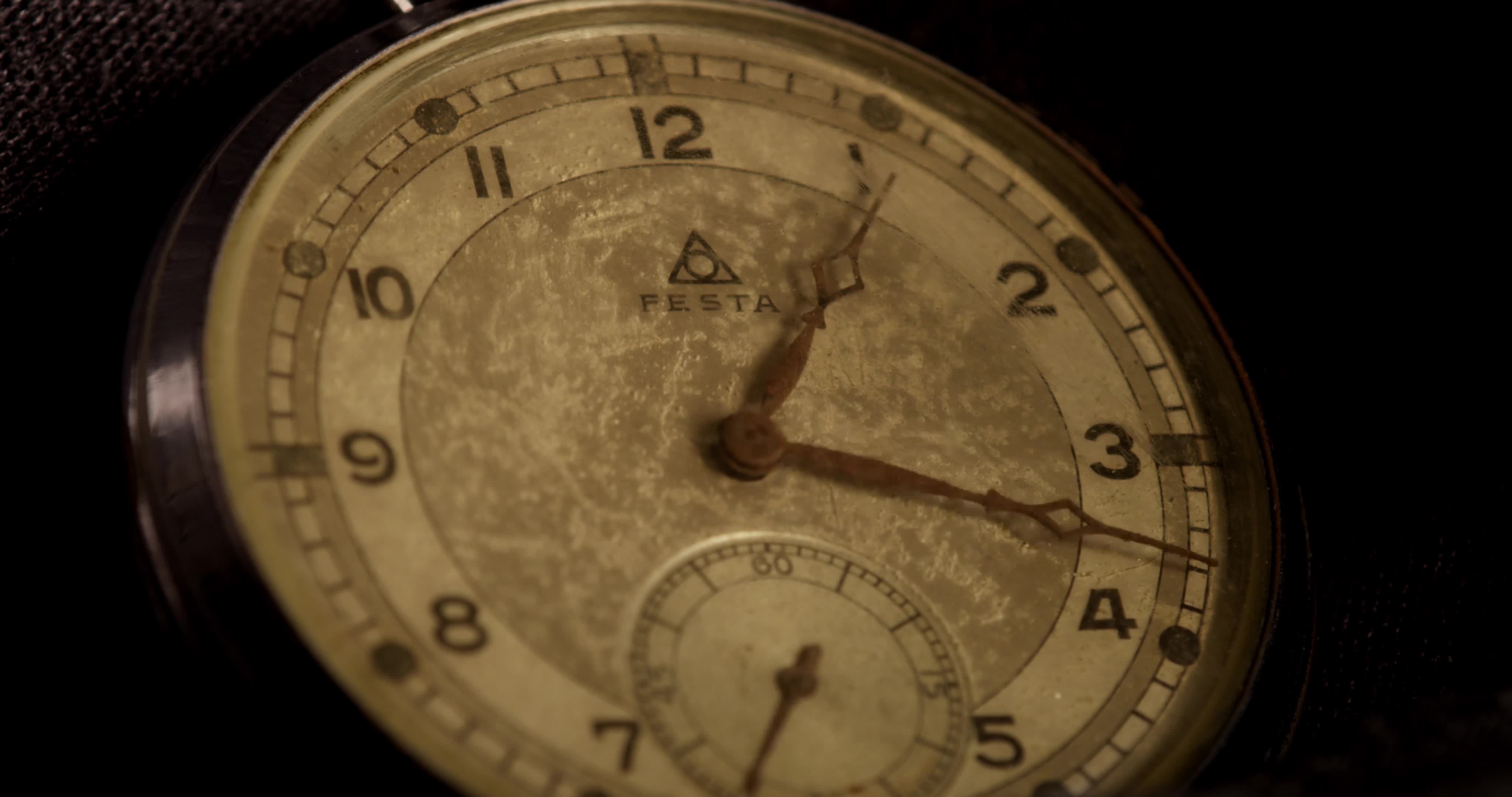 Extreme close up shot of clock hands moving from 1205 to 800 in 4K