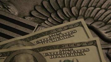 Rotating stock footage shot of American paper currency on an American eagle shield background - MONEY 0406 video