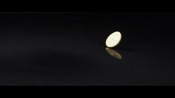 Spinning coin on a reflective surface - MONEY 0046 video