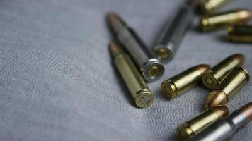 Cinematic rotating shot of bullets on a fabric surface - BULLETS 096 video