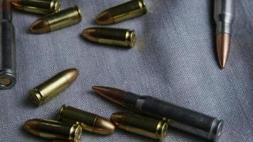 Cinematic rotating shot of bullets on a fabric surface - BULLETS 091 video