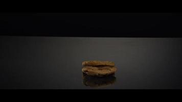 Falling cookies from above onto a reflective surface - COOKIES 243 video