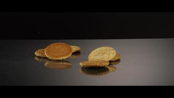 Falling cookies from above onto a reflective surface - COOKIES 225 video