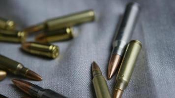 Cinematic rotating shot of bullets on a fabric surface - BULLETS 097 video