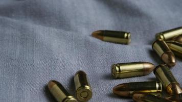 Cinematic rotating shot of bullets on a fabric surface - BULLETS 085 video