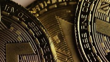 Rotating shot of Bitcoins (digital cryptocurrency) - BITCOIN MONERO 058