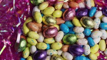 Rotating shot of colorful Easter candies on a bed of easter grass - EASTER 158 video