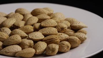 Cinematic, rotating shot of almonds on a white surface - ALMONDS 154 video