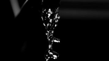 Water pouring from a faucet in ultra slow motion 1,500 fps on a reflective surface - WATER FAUCET 003 video