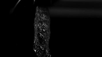 Water pouring from a faucet in ultra slow motion 1,500 fps on a reflective surface - WATER FAUCET 006 video